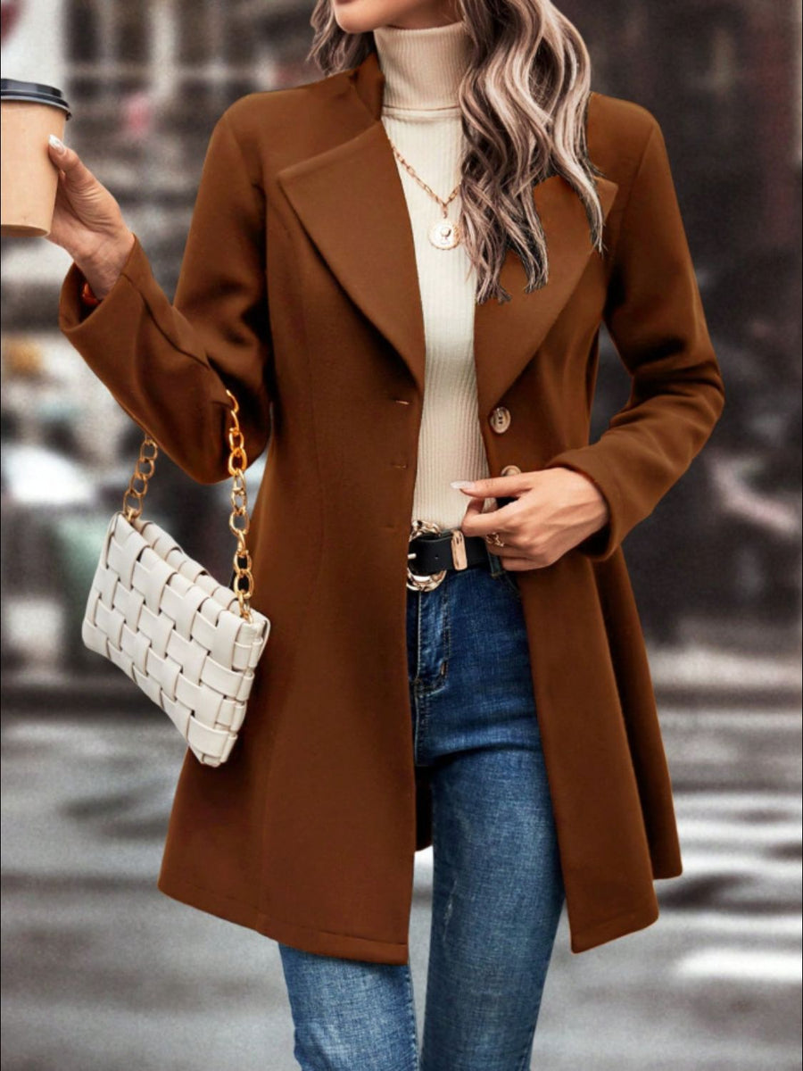 Caramel wool blend coat with flared hemline and button closure, styled with jeans.