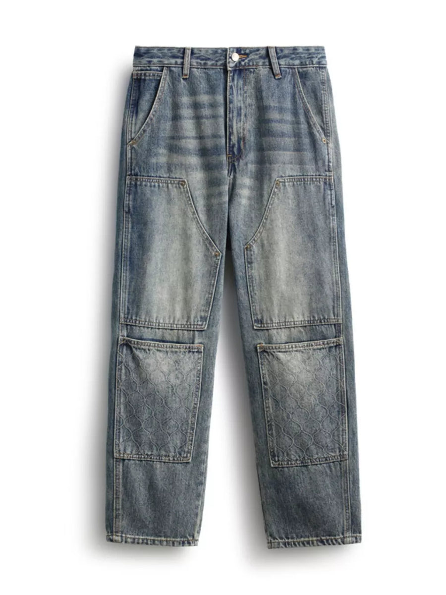 Men's blue straight leg jeans with patchwork and textured pockets.