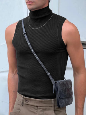 Black ribbed sleeveless turtleneck shirt with a high neck, styled with a silver chain and crossbody bag.