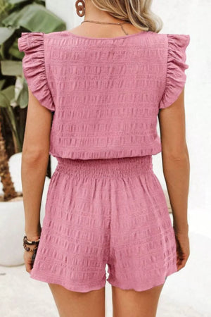 Pink textured two-piece set with ruffled cap sleeves and smocked waist shorts.