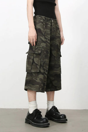 Pleated camo culotte cargo shorts in green camouflage with large side pockets.
