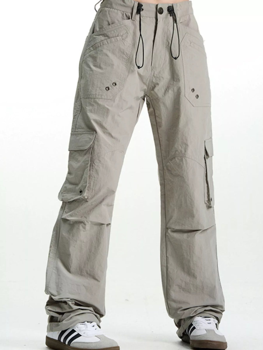 Grey relaxed fit cargo pants with multiple pockets and drawstring waist.