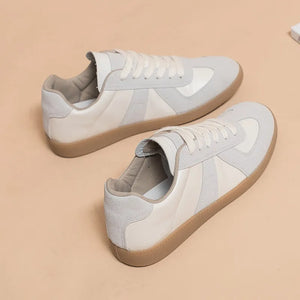 Beige leather sneakers with suede panels and gum sole.