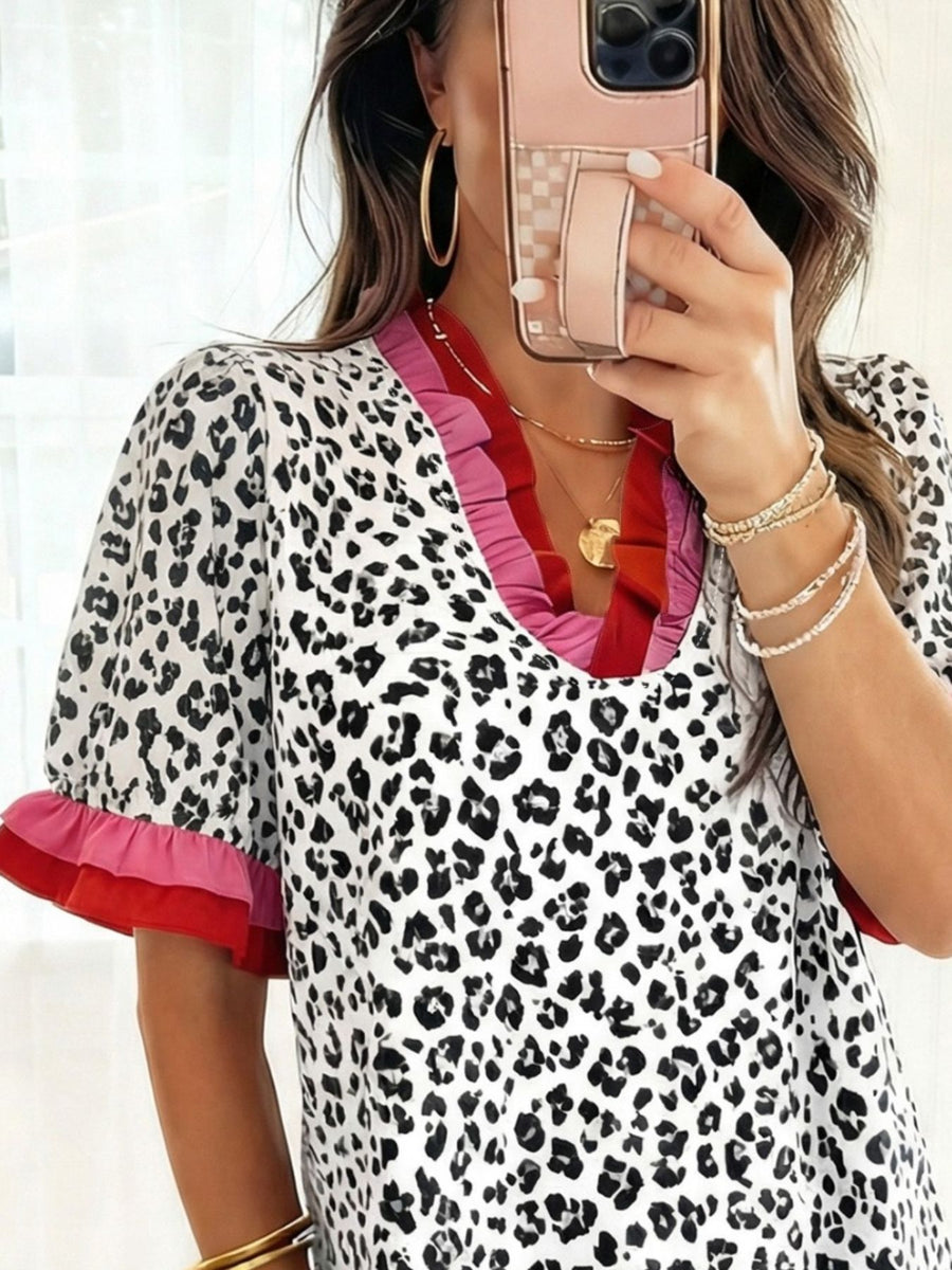 Leopard print blouse with ruffled neckline and sleeves in strawberry and black.