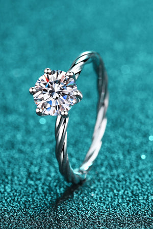 Silver twisted band ring with a round moissanite solitaire gemstone.
