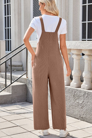 Caramel ribbed knit wide-leg overalls with patch pockets, styled with a white tee.