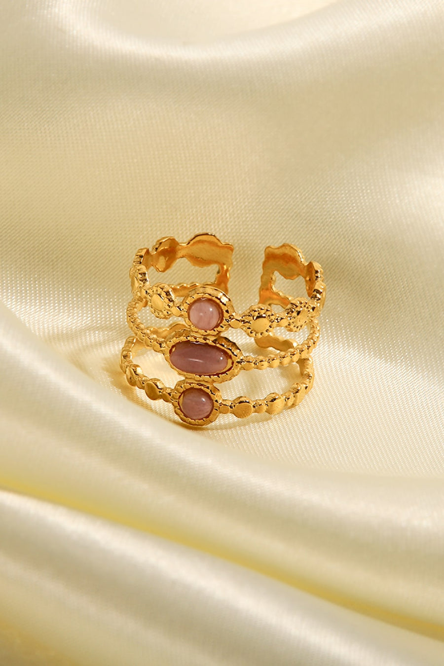 Gold triple stone openwork ring with pink stones and beaded detail