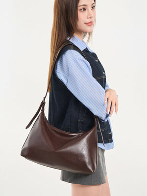 crossbody bag in dark brown featuring adjustable strap and relaxed fit