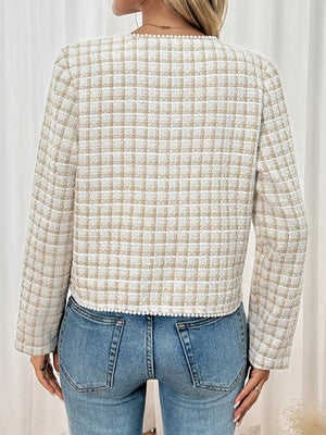 Apricot tweed jacket with pearl trim and plaid pattern.