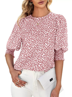 Pink animal print half sleeve blouse with smocked cuffs and puff sleeves.