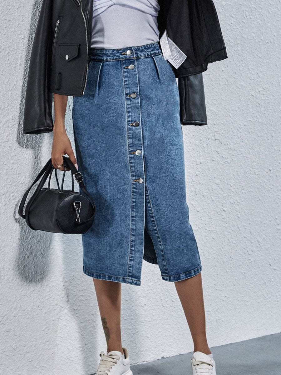 Button-front denim midi skirt in light wash with pleats and a slit.
