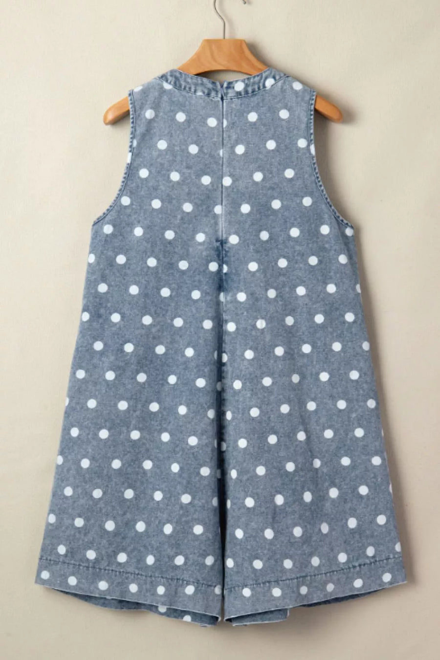 Denim polka dot romper with a tie-front detail and a high neckline.
