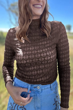dark brown blouse with geometric and mock neck