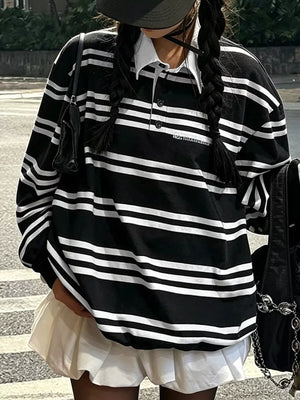 white polo shirt featuring buttoned placket and striped