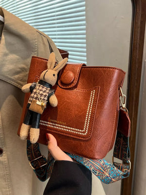 crossbody bag in cognac featuring adjustable strap and boxy fit
