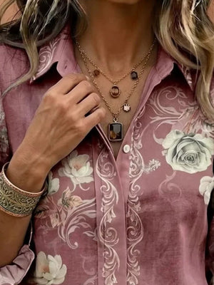 cream button-down shirt featuring button cuffs and floral