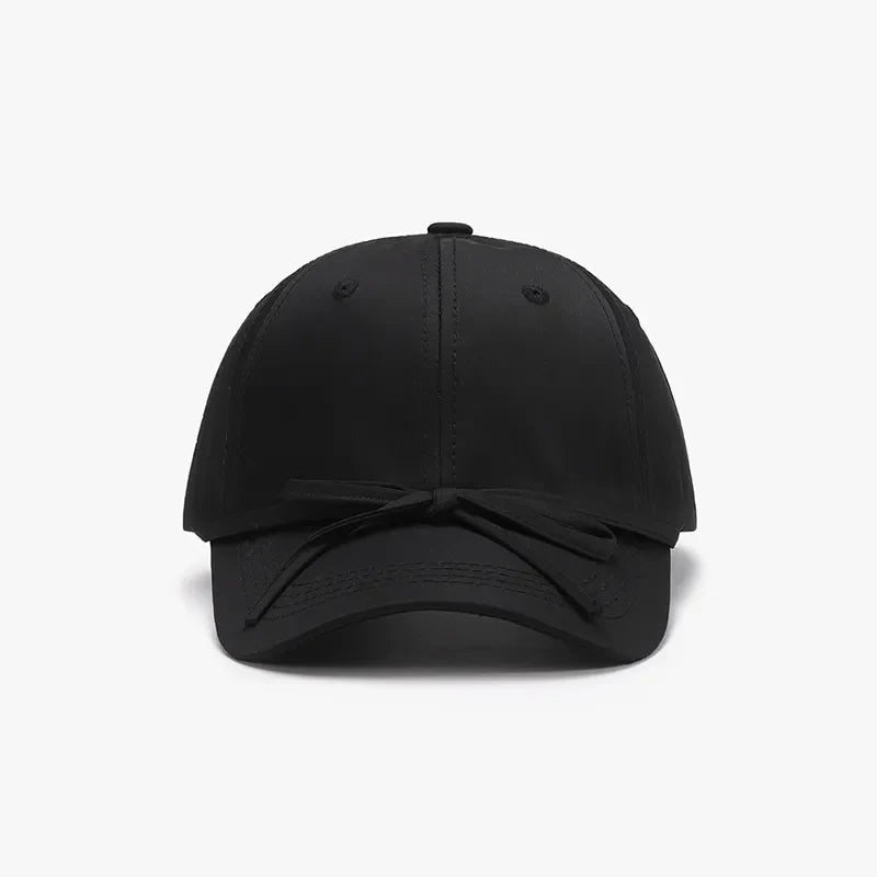 Black baseball cap with a tied bow detail on the brim