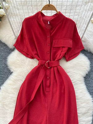 Red belted wide leg romper with button-down front and short sleeves.