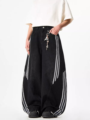 Black wide-leg jeans with white side stripes and acid wash detail.