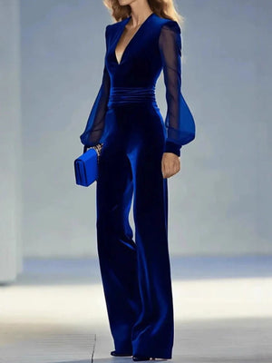Royal blue velvet jumpsuit with sheer balloon sleeves and wide legs.