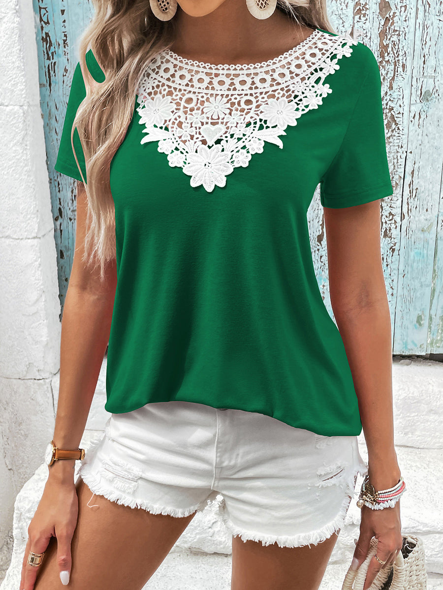 Green t-shirt with short sleeves and a white floral lace yoke detail.