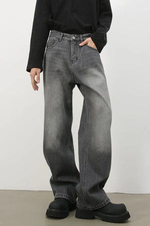 Faded dark gray cotton denim jeans with a wide-leg silhouette and gradient wash.