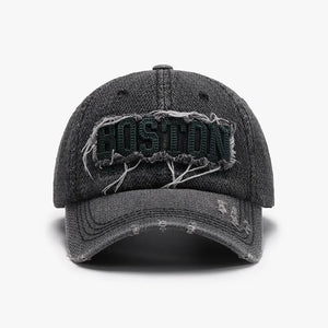 Distressed denim baseball cap in dark gray with embroidered Boston text and frayed details.