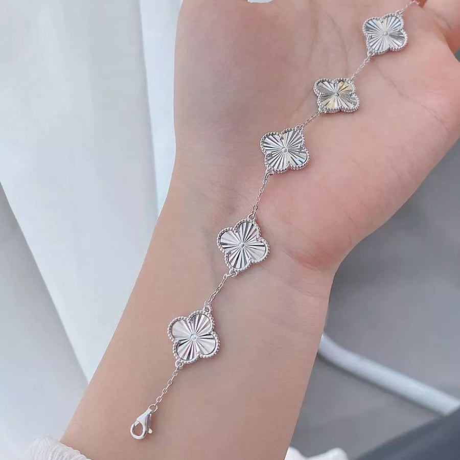 silver bracelet with clasp and four-leaf clover