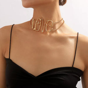 Gold necklace featuring statement piece and script
