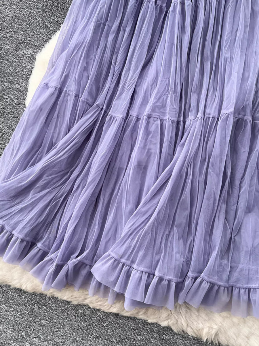 Purple tiered tulle skirt with ruffled hem and lining, showing fabric texture.