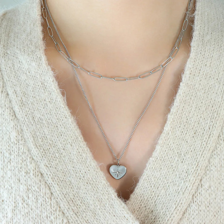Silver layered necklace with paperclip chain and heart pendant with star detail