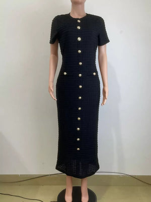 Black textured midi dress with gold buttons and short sleeves.