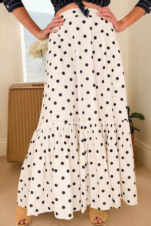 Chic polka dot maxi skirt in white with navy dots and ruffled hem.