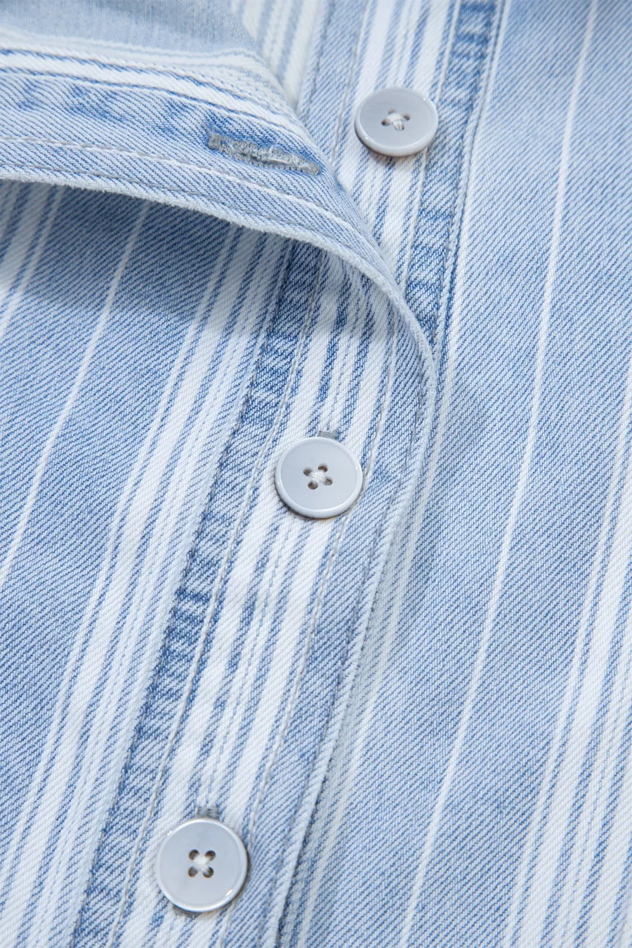 Denim shacket with blue and white vertical stripes, button-down front, and light grey buttons.