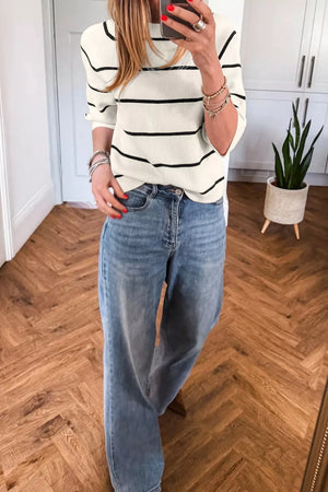 Chic striped ribbed knit top in white with black stripes, crew neck, long sleeves.