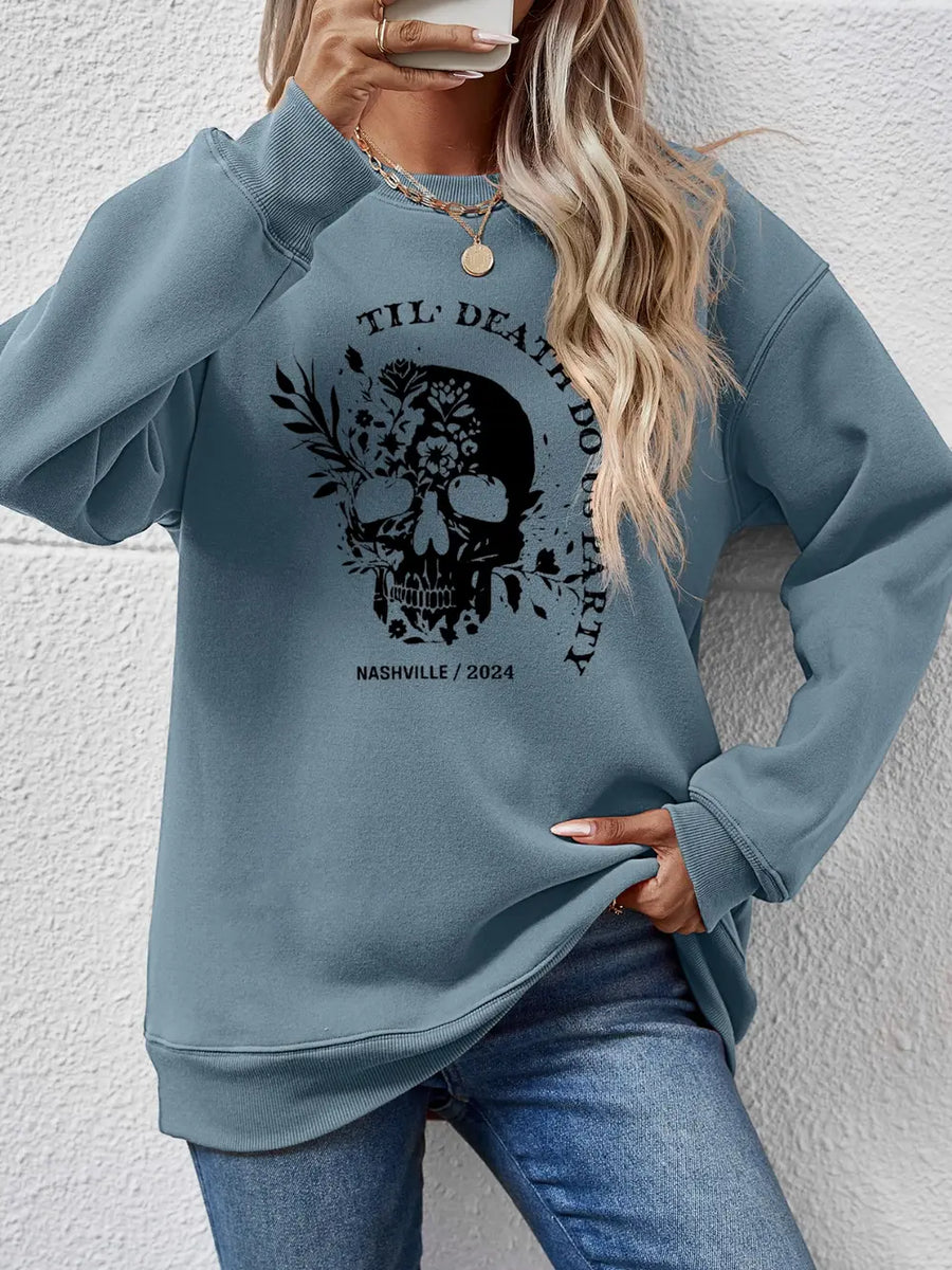 Air Force Blue raglan sweatshirt with floral skull graphic and text.