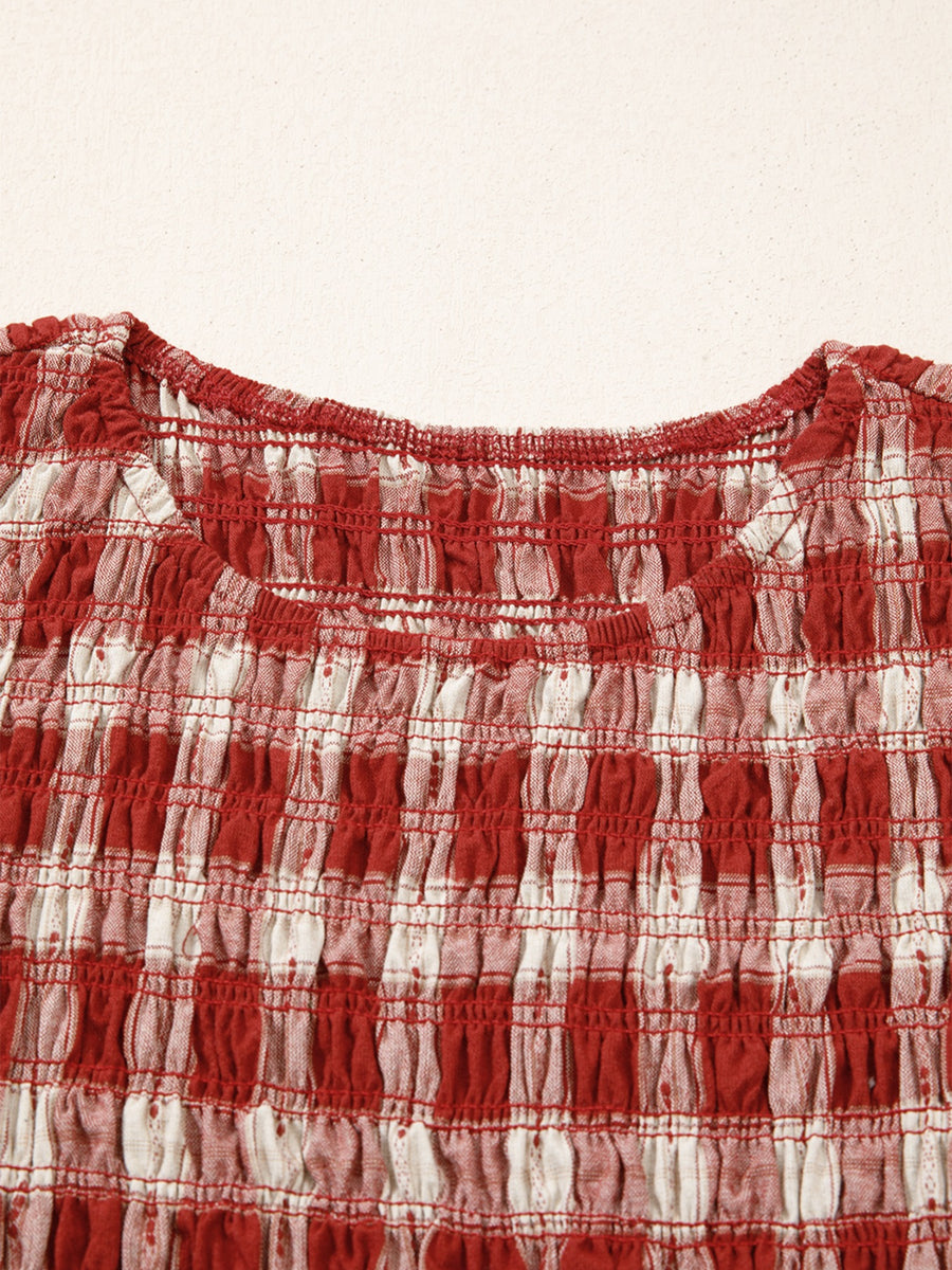 Red and white gingham smocked mini dress with a scoop neck and puff sleeves.