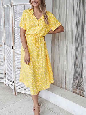 Yellow polka dot midi dress with tie waist, short sleeves, and collared neckline.