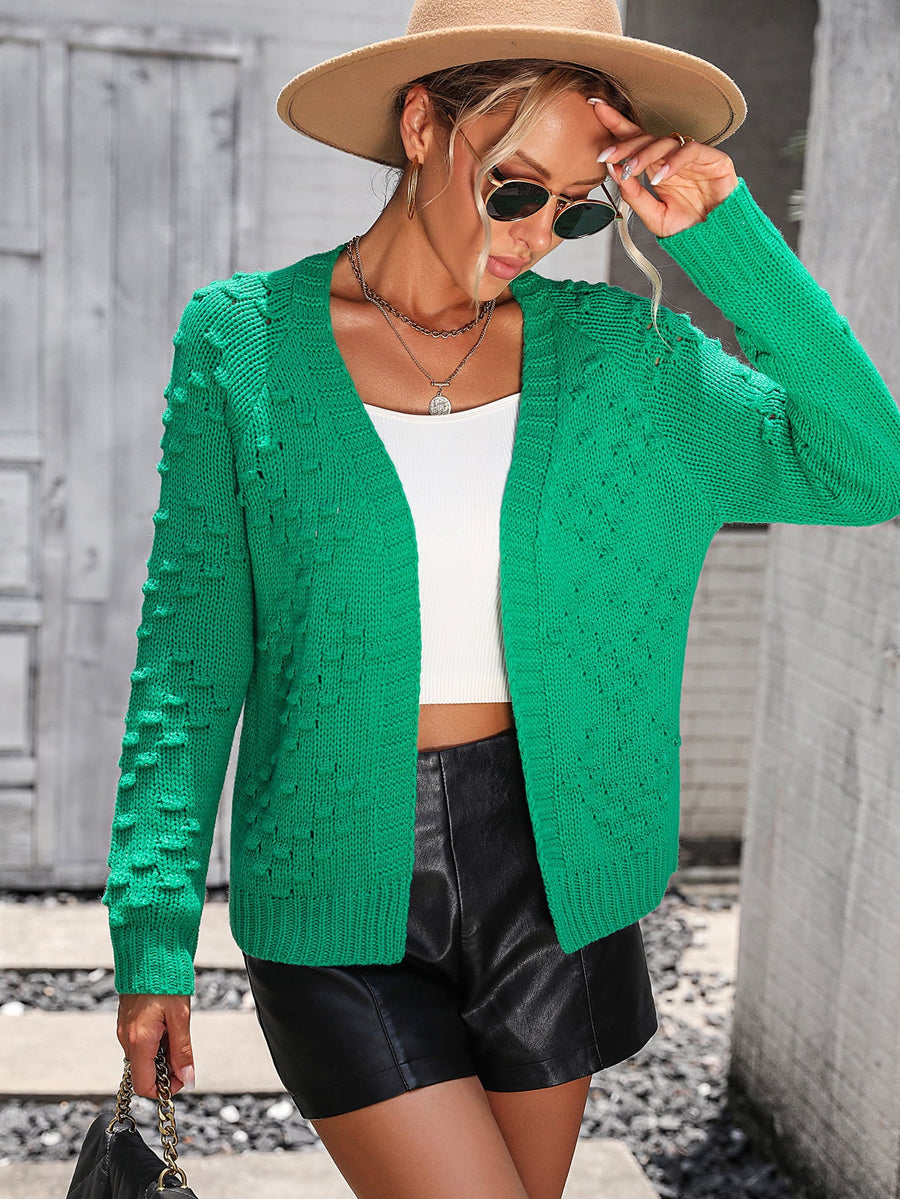 Green acrylic knit cardigan with textured sleeves and open front.