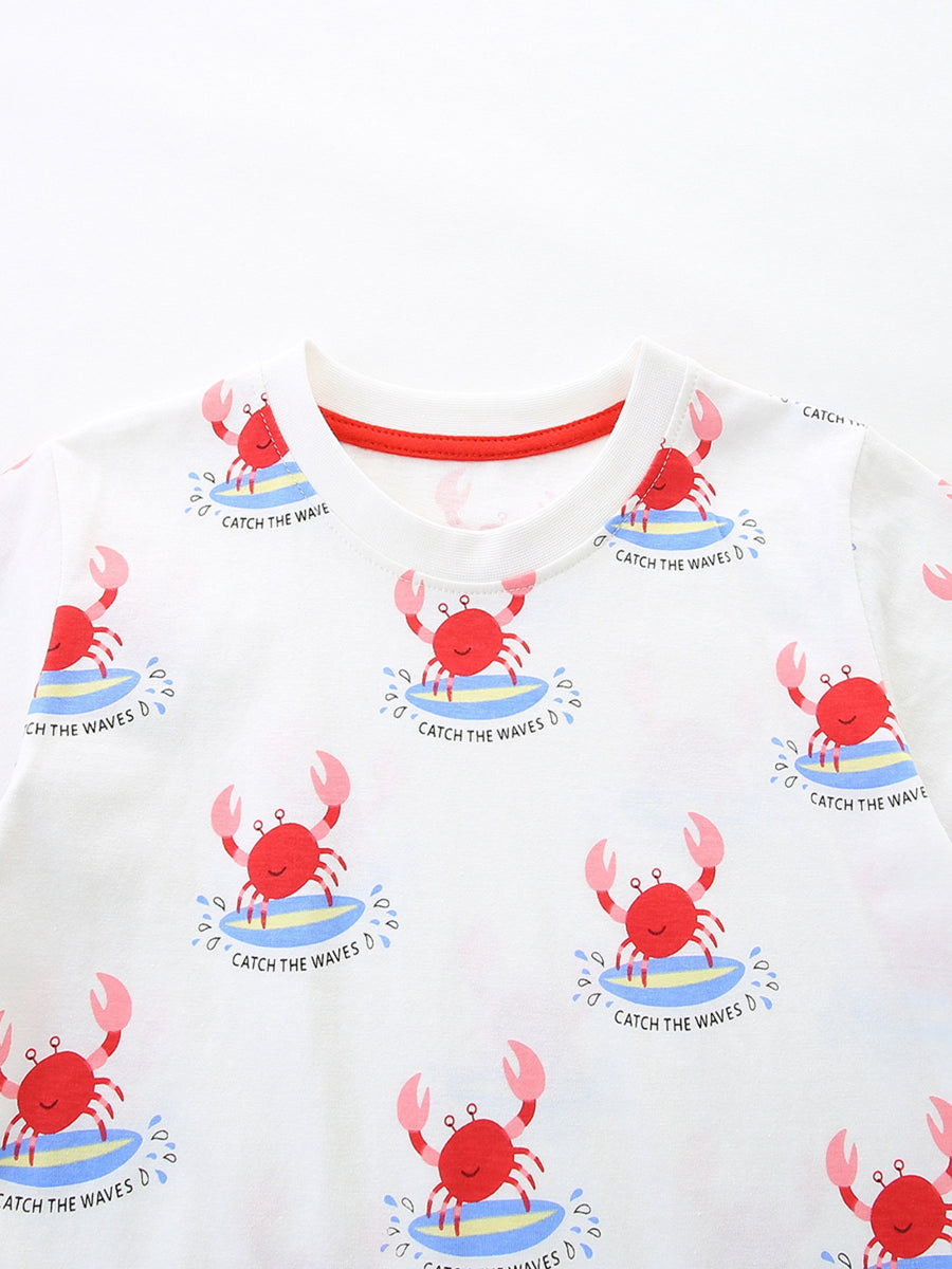 White cotton toddler t-shirt with all-over red surfing crab print and red neckline trim.