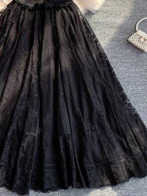 Black lace dress with puff sleeves and intricate lace detailing.