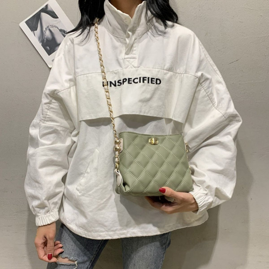 Green quilted crossbody bag with diamond pattern and gold chain strap.