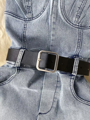 Blue denim romper with allover rhinestones and black belt with silver buckle.