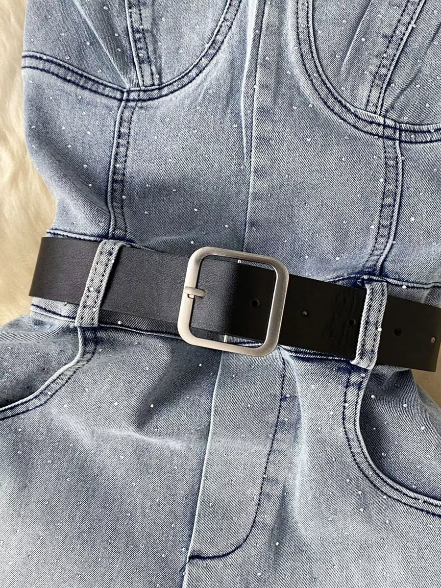 Blue denim romper with allover rhinestones and black belt with silver buckle.
