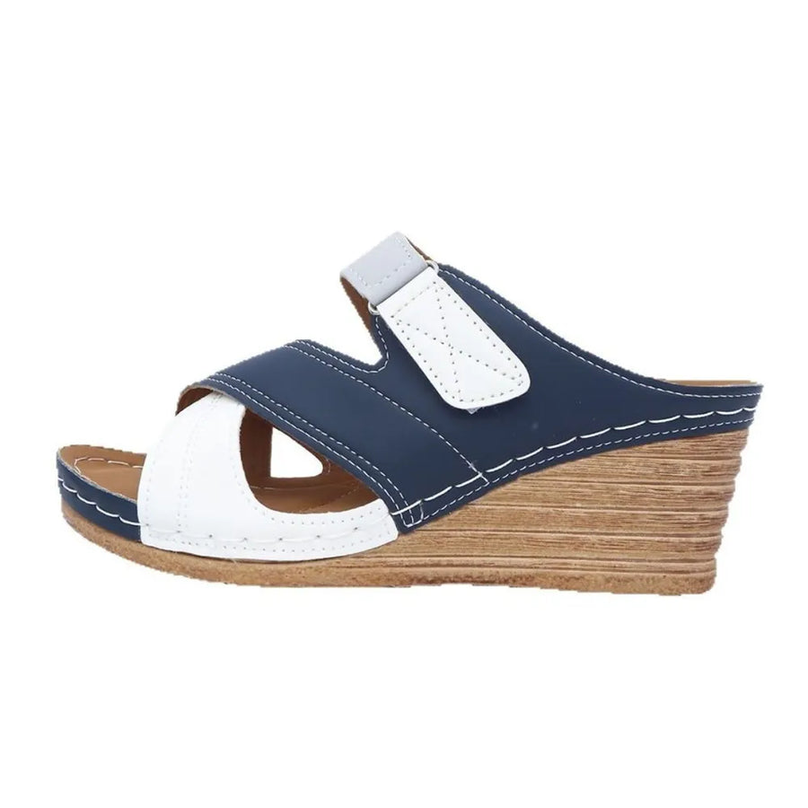 Navy and white colorblock crossover wedge sandals with adjustable strap.