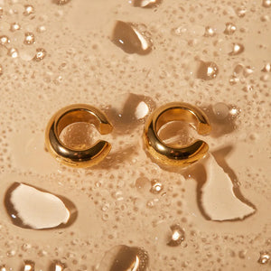 Sculptural gold-tone ear cuff duo with contemporary design and clip-on style.