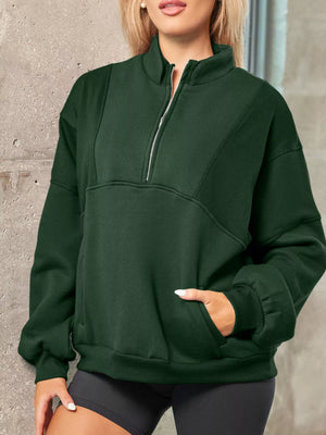 Dark green half zip stand collar sweatshirt with a front pocket and ribbed cuffs.