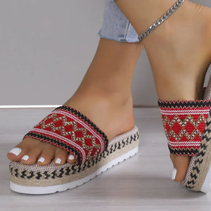 Embroidered platform espadrille slides in red with woven jute sole and white toenails.