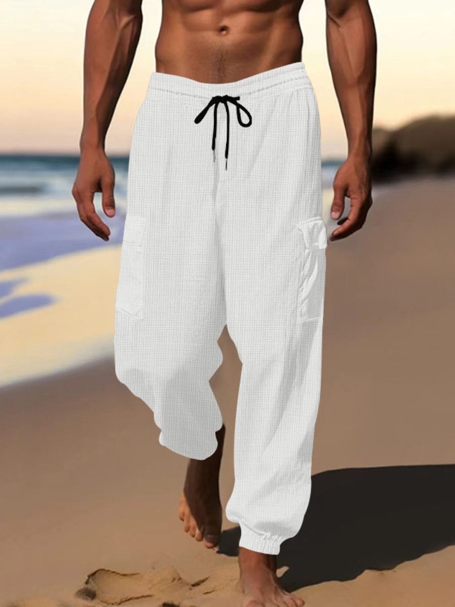 White waffle knit joggers with drawstring and cargo pockets.