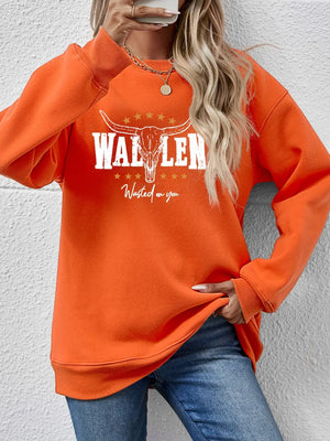 Orange graphic sweatshirt with bull skull and text, drop shoulder, crew neck.
